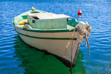 Small wooden fishing boat moored in harbour
