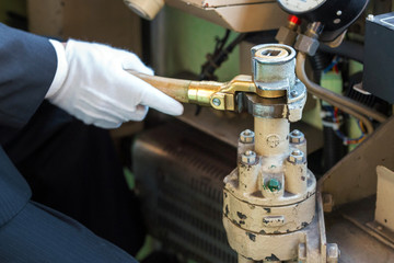 The driver in white gloves holds the lever, Kyoto, Japan. Close-up.