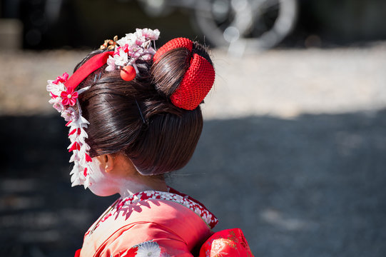 KYOTO, JAPAN - NOVEMBER 7, 2017: Portrait of a little japanese girl in kimono. Back view. Copy space for text.