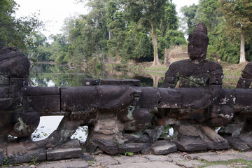 Angkor Cambodia, statue of guardian Asura on the causeway that crosses the moat to the west entrance at the 12th century Preah Khan temple