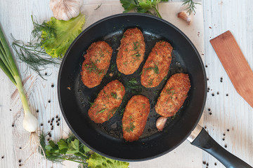 cutlets in a frying pan, top view