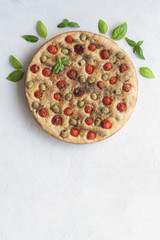 Homemade oven-baked  italian  focaccia - focaccia Barese, with olives, olive oil, tomatoes, herbs