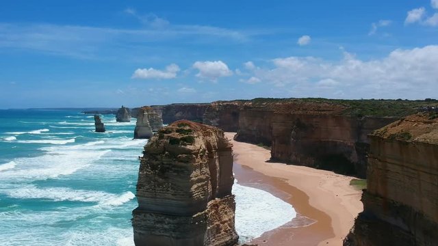 Stunning aerial drone view of the Twelve Apostles, a collection of limestone stacks & tourist attraction off the shore of Port Campbell National Park, by the Great Ocean Road in Victoria, Australia.