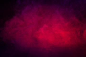 Colored purple and red smoke on a black background closeup