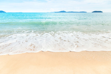 Beautiful white soft wave splashing on the beach 