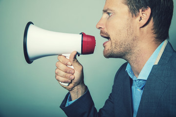 business leadership - businessman giving instructions with megaphone