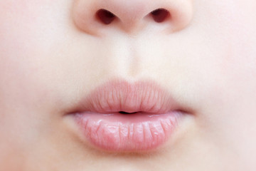 Naklejka premium Smiling child close-up. Lips close-up.