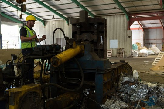 Worker operating a machine in the scrapyard