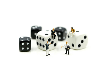 Miniature people : businessman standing with Black and white dices,Business competition Concept.