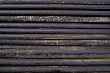 Oil Drill pipe. Rusty drill pipes were drilled in the well section. Downhole drilling rig. Laying the pipe on the deck. View of the shell of drill pipes laid in courtyard of the oil and gas warehouse.
