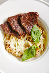 Mushrooms Risotto with Grilled Slices of Beef in White Plate Top View