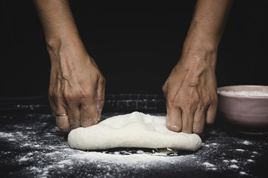 woman's hands kneading bread