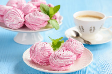 Homemade berry zephyr or marshmallow, on blue wooden background.