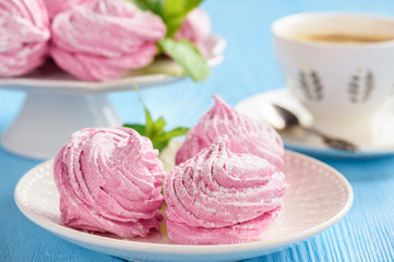 Homemade berry zephyr or marshmallow, on blue wooden background.