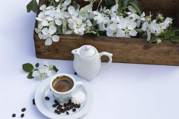 on a white canvas is an old wooden box with apple tree branches, a cup of coffee, a teapot and coffee beans