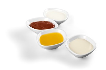 the various barbecue sauces in ceramic bowls