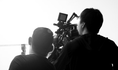 Movie shooting or video filming production by crew team and professional equipment such as super...