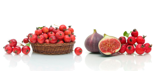 figs, apples and hawthorn berries on a white background