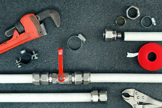 Plumber tools on concrete structure background.Top view.Home repair concept.