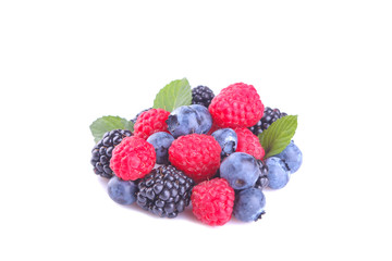 Various fresh berries close-up including blueberries, raspberries, blackberries on a white background. isolated