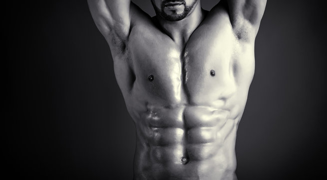 Naked breast. Male body. Tanned, perfect skin of seductive male model. Six pack abs and well trained chest muscules. Man's ideal body shape. Striptease theme and entertainment. Skin care for men