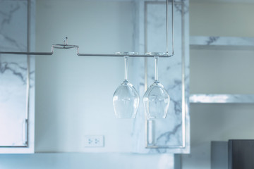 couple clear wine glass hang in empty kitchen