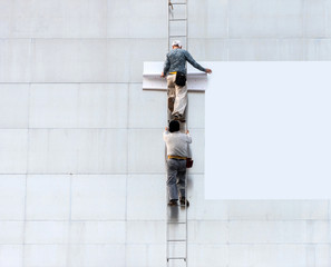 Workers hang a banner on the facade of a building, Tokyo, Japan. Copy space for text. Frame for text.