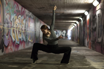 Fototapeta na wymiar Modern Dancer in Motion Dancing in a Tunnel