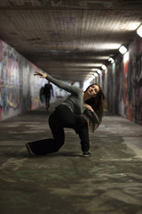 Female Dancer in Motion Dancing in an Urban Underpass