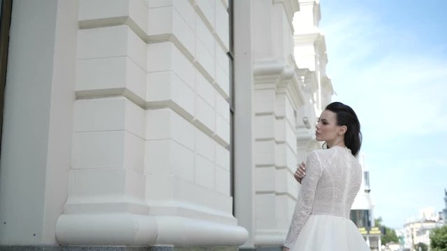 Woman is looking at the door of a shop