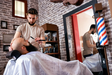 Hairdresser shaves man's beard