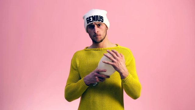 The guy in the cap moves his ears and looks at the lamp that holding in his hand. Genius concept.