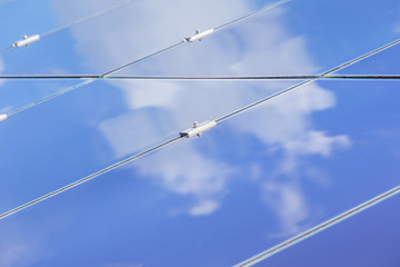 Close up array of  thin film solar cells or amorphous silicon solar cells or photovoltaics in solar power plant turn up skyward 