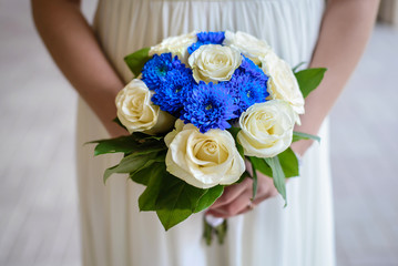 Wedding bouquet in the hands of the bride