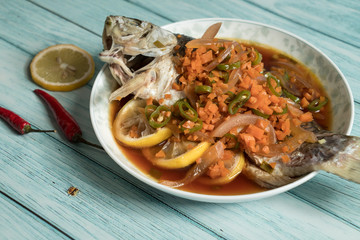Lemon fish and wood grain background