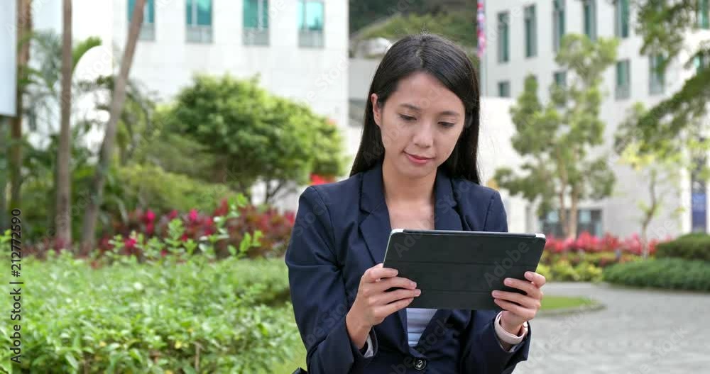 Poster Asian Businesswoman use of digital tablet computer at outdoor