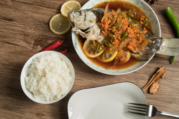 Lemon fish and wood grain background