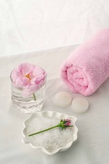Obraz na płótnie Canvas Spa resort therapy composition. Candles, rose flower, salt, towel. Relax, wellness and mindfulness concept