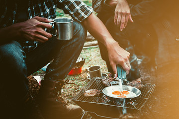 Preparing food on campfire in wild camping