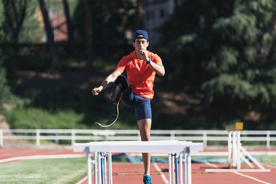 Disabled man athlete training with leg prosthesis.