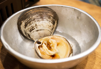 Cooked shellfish in a stainless steel plate, Tokyo, Japan. Close-up.