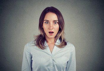 Amazed young woman looking at camera