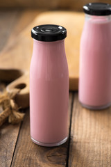 strawberry milk bottle on wood

