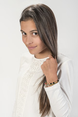 Cute youngster caressing her long hair Beautiful face that transmits innocence and tranquility