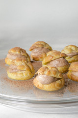 Chocolate mousse filled bun Preparing Italian profiterole dessert with cocoa