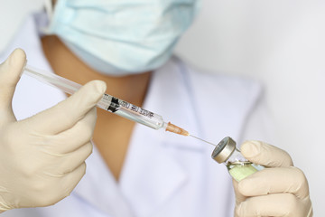 Doctor hand holding draw syringe and medicine bottle on white background, Medicine concept