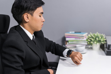 business man checking time on smart watch