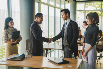 Executives and secretaries Joining hands after successful business deal.