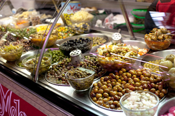 Bowls of olives for sale at a market shop-window