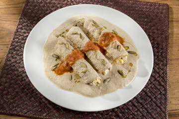 Mayan enchiladas called Papadzules. Typical Yucatan, Mexican dish called Papadzules made with Pumpkin seed sauce